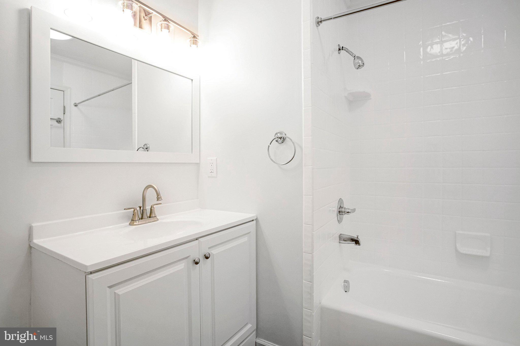 4350 Camp Kaufmann Road Huntingtown, MD 20639 - Photo 9 of 23 a bathroom with a sink a mirror and a bathtub
