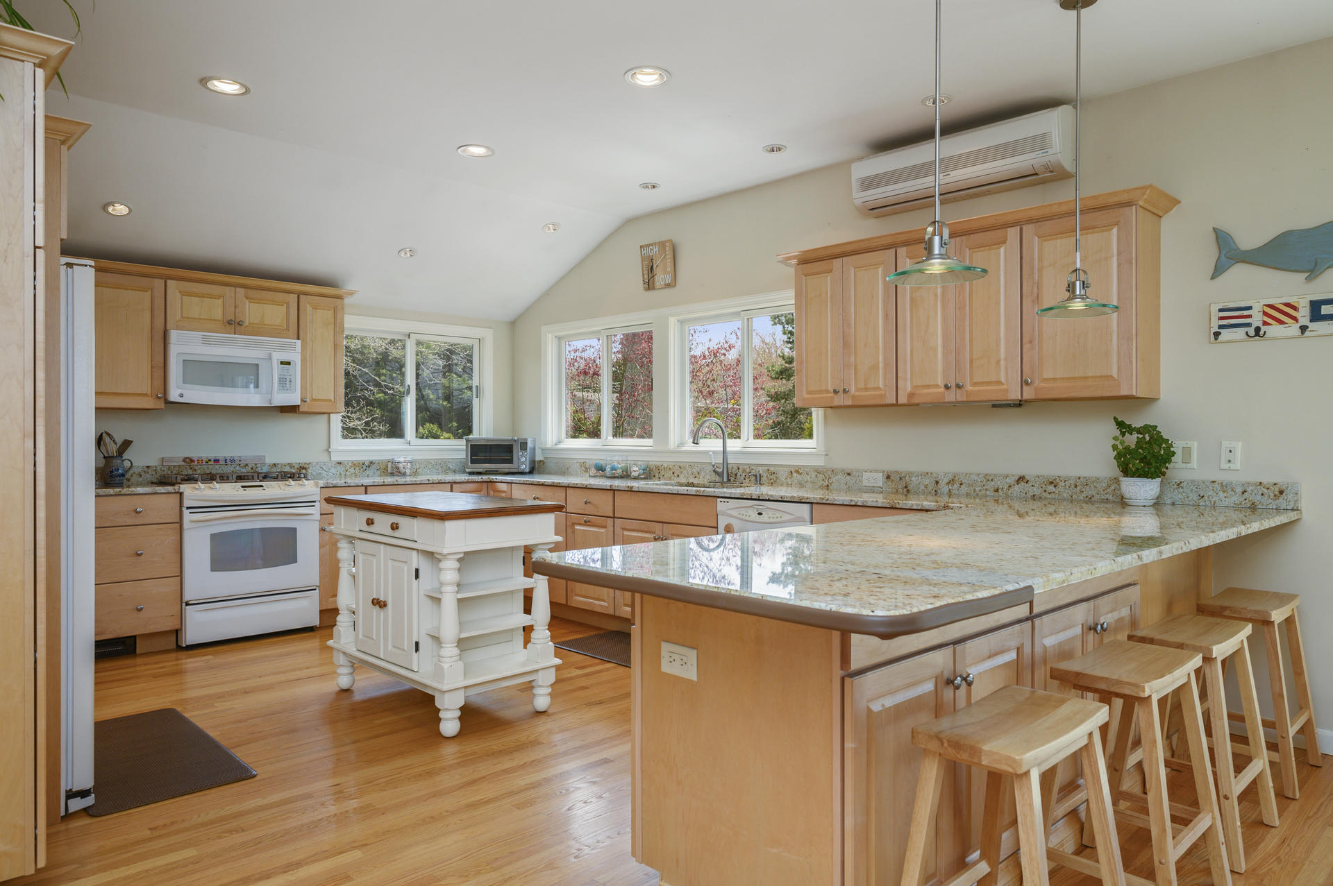 48 Locust Road Orleans, MA 02653 - Photo 11 of 36 a kitchen with granite countertop a sink a counter space appliances and cabinets