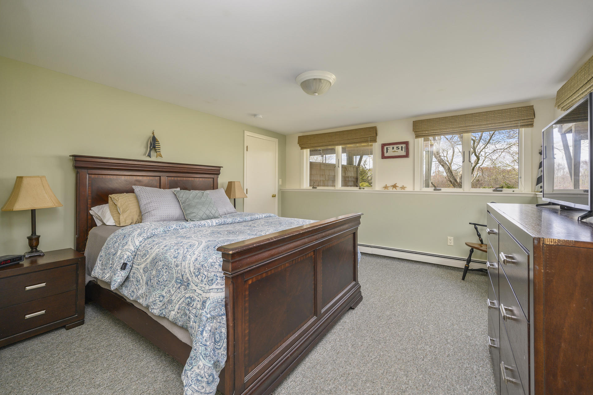 48 Locust Road Orleans, MA 02653 - Photo 21 of 36 a bedroom with a bed and large windows