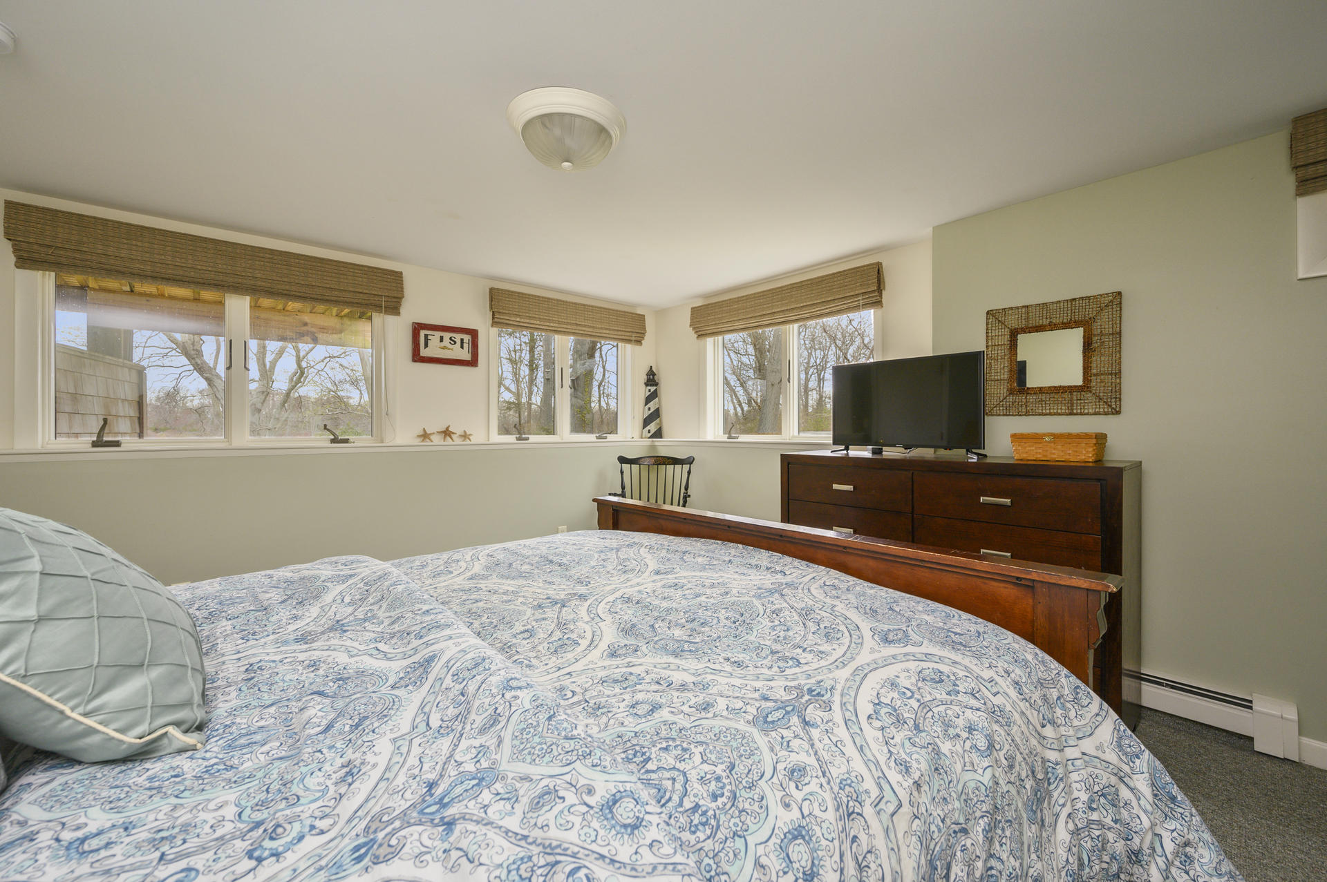 48 Locust Road Orleans, MA 02653 - Photo 22 of 36 a bedroom with a bed and a flat screen tv