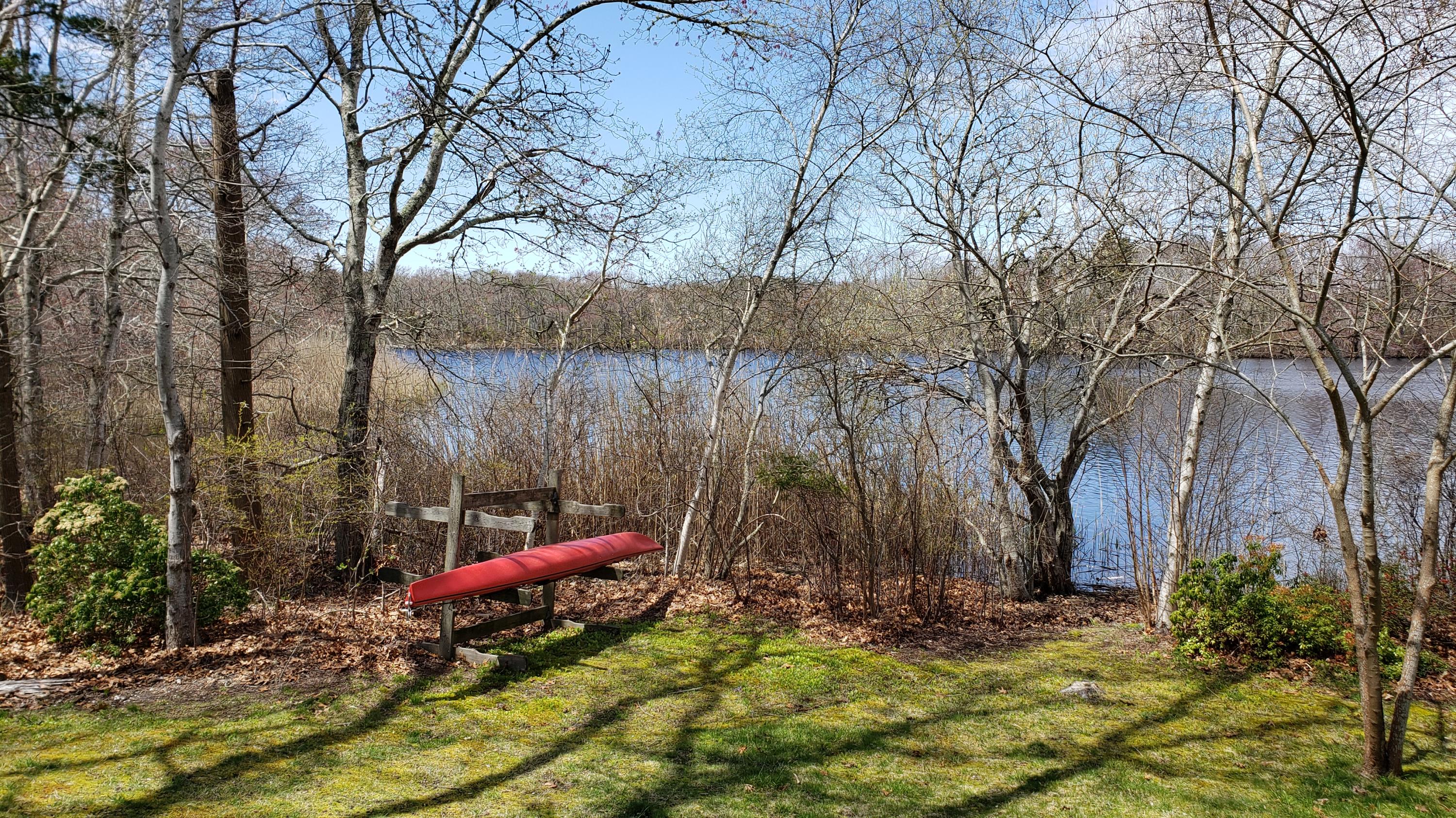 48 Locust Road Orleans, MA 02653 - Photo 30 of 36 a backyard of a house with table and chairs