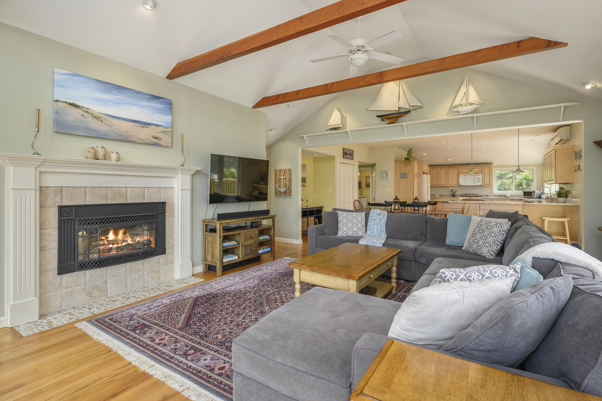 48 Locust Road Orleans, MA 02653 - Photo 8 of 36 a living room with furniture a flat screen tv and a fireplace