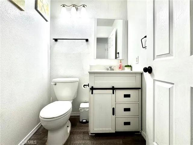 a bathroom with a sink a toilet and shower curtain