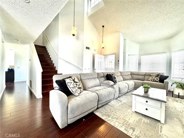 a living room with furniture and wooden floor