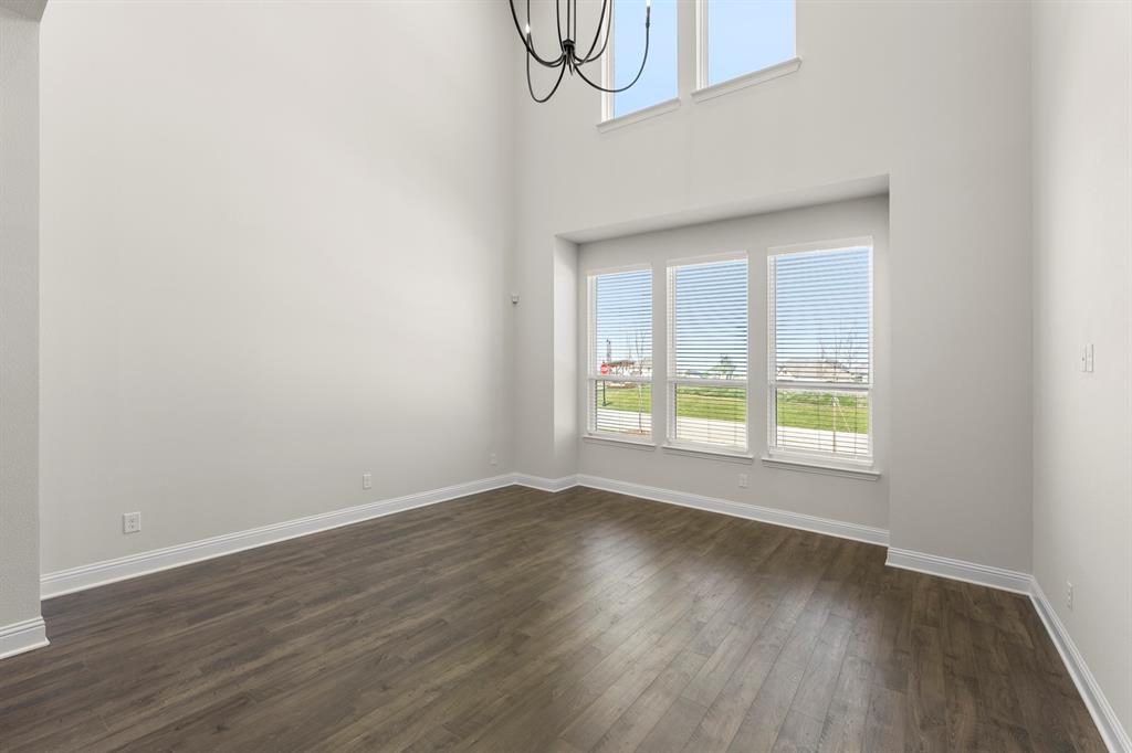 3916 Keya Drive Prosper, TX 75078 - Photo 12 of 28 a view of an empty room with wooden floor and a window