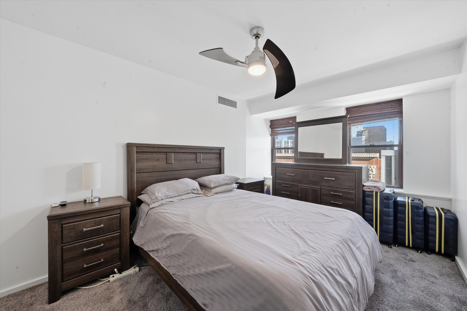 40 East 9th Street, Unit 1005 Chicago, IL 60605 - Photo 11 of 30 a bedroom with a bed and dresser