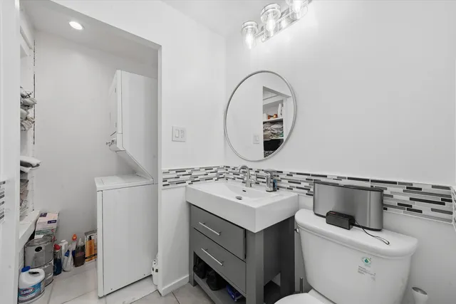 a bathroom with a sink mirror and toilet