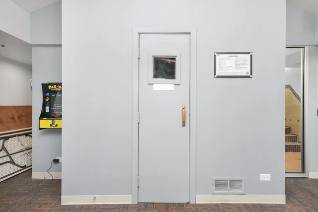 a view of a hallway with wooden floor and windows