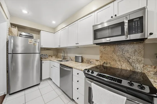 a kitchen with stainless steel appliances a stove a microwave and a refrigerator