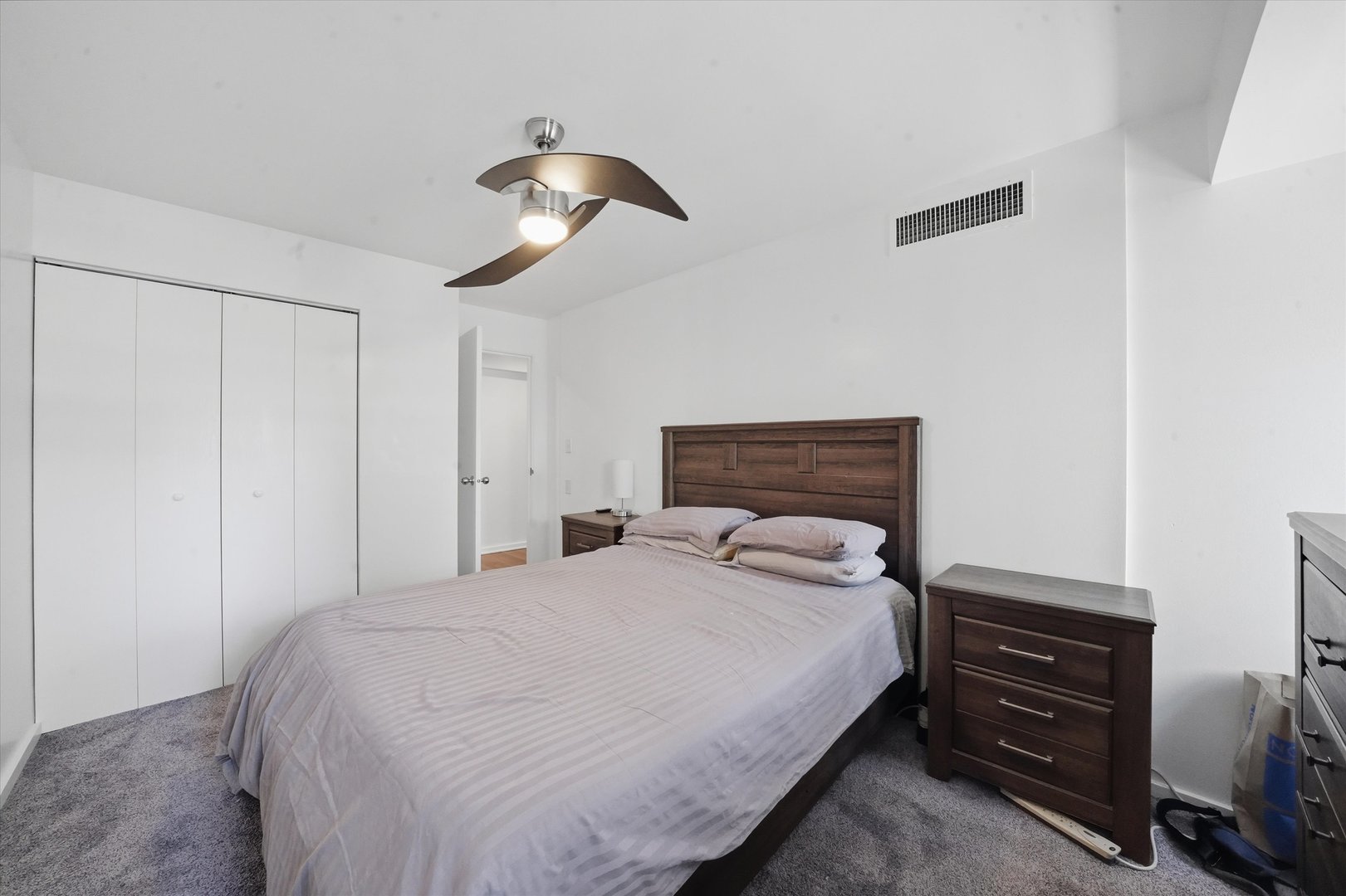 40 East 9th Street, Unit 1005 Chicago, IL 60605 - Photo 10 of 30 a bedroom with a bed and a chandelier
