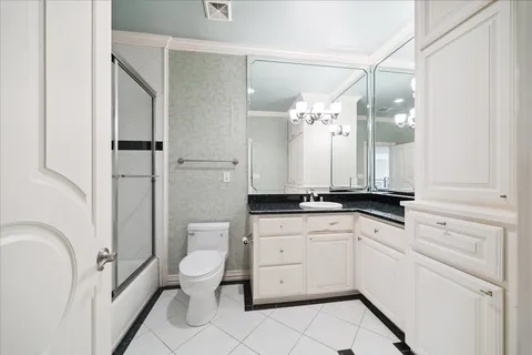 a hallway with cabinets and wooden floor