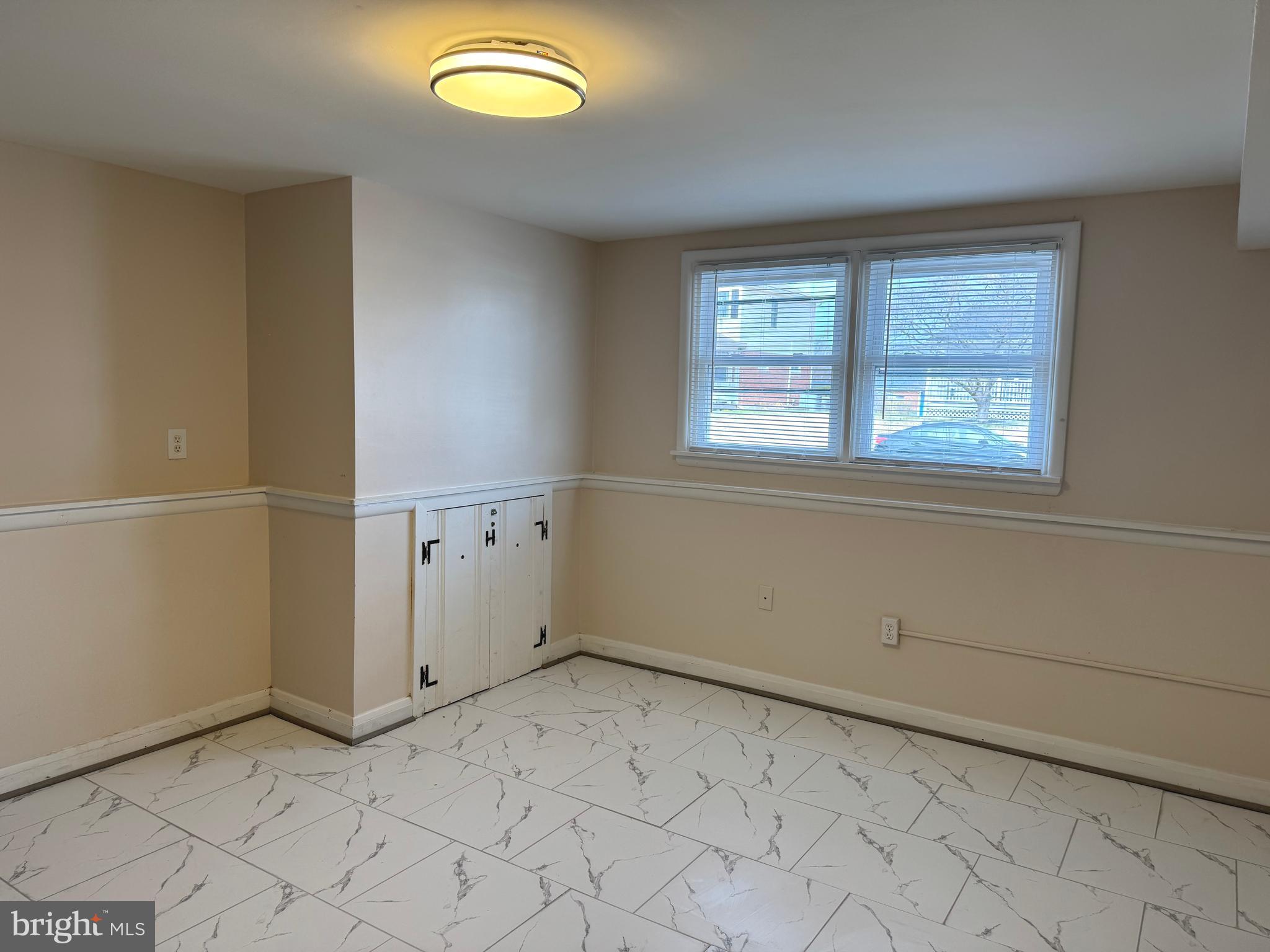 609 Wallerson Road Baltimore, MD 21228 - Photo 9 of 15 an empty room with windows