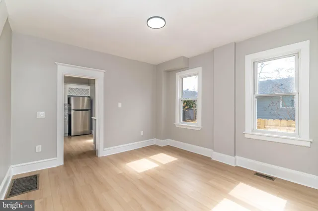 an empty room with windows and closet