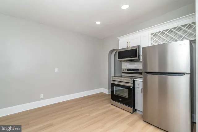 a kitchen with a refrigerator and a microwave