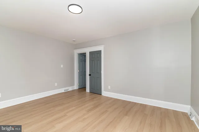 a view of an empty room and wooden floor