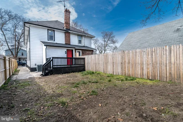 a view of a house with wooden fence