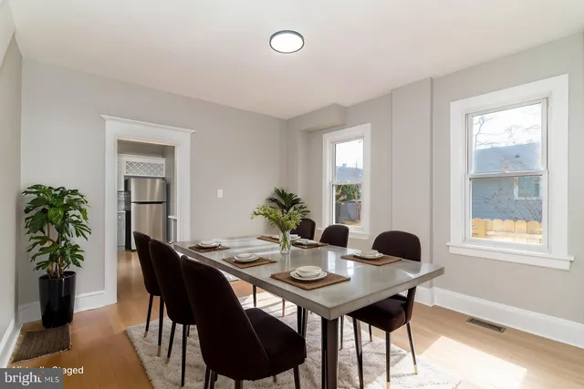 a view of a dining room with furniture and window