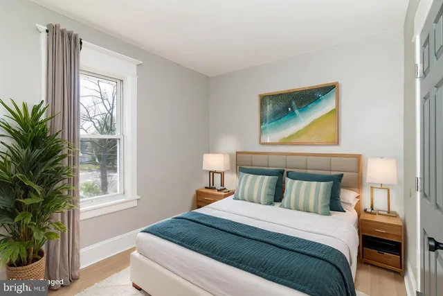 a bedroom with a bed and a potted plant