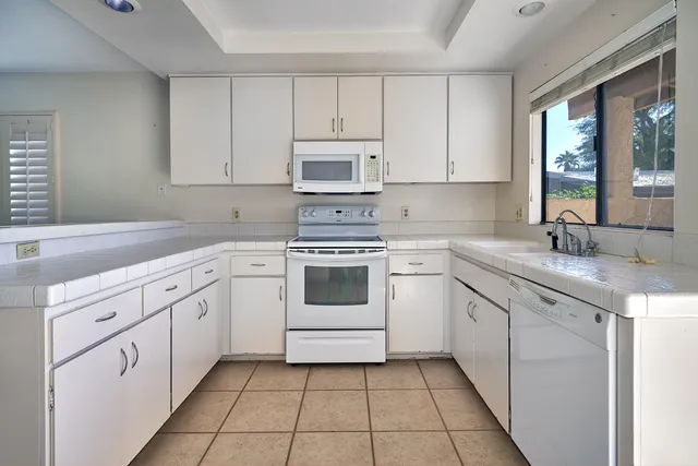 a kitchen with a stove a sink and a refrigerator