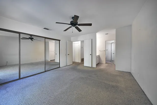 a spacious bathroom with a double vanity sink mirror and toilet
