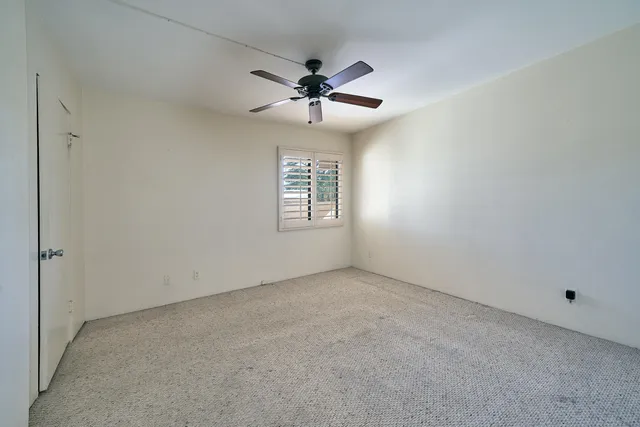 a bathroom with double vanity and a mirror