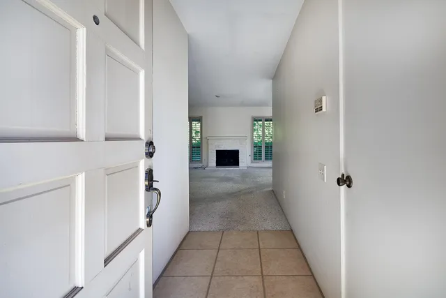 a hallway with a white stove next to a refrigerator