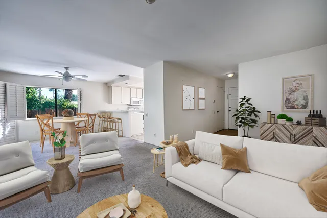 a living room with furniture or couch and a large window