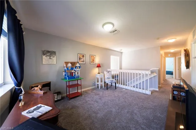 a view of a livingroom with furniture and a flat screen tv