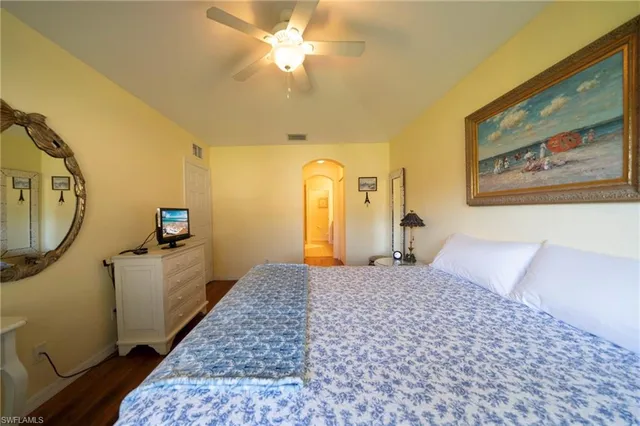 a bedroom with a bed and a painting on the wall