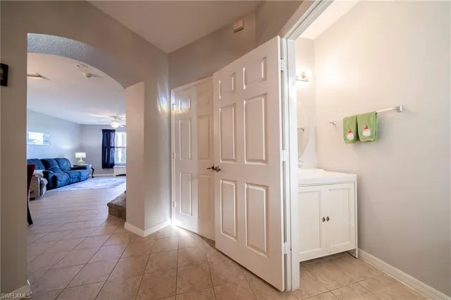 a view of a hallway with wooden floor windows and a bathroom