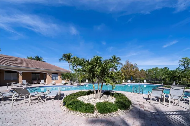 a swimming pool with outdoor seating and yard