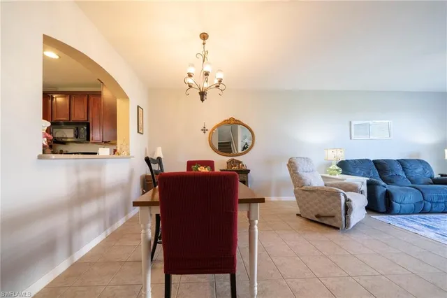 a living room with furniture and a mirror