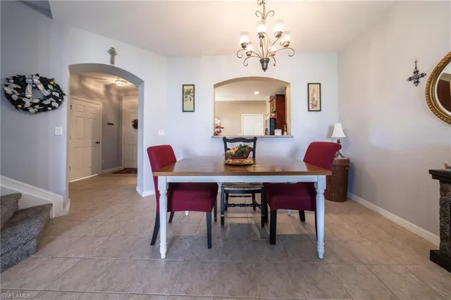 a dining room with furniture a chandelier and a rug