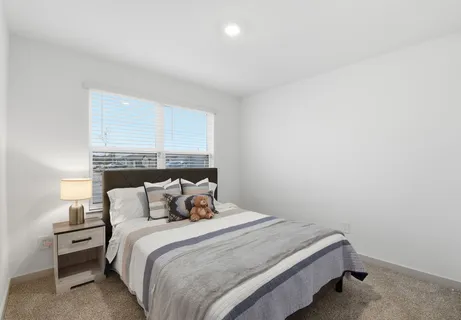 a kitchen with a dining table chairs and refrigerator