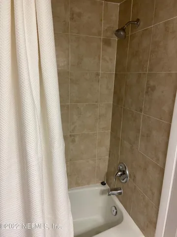 a bathroom with a shower and a sink