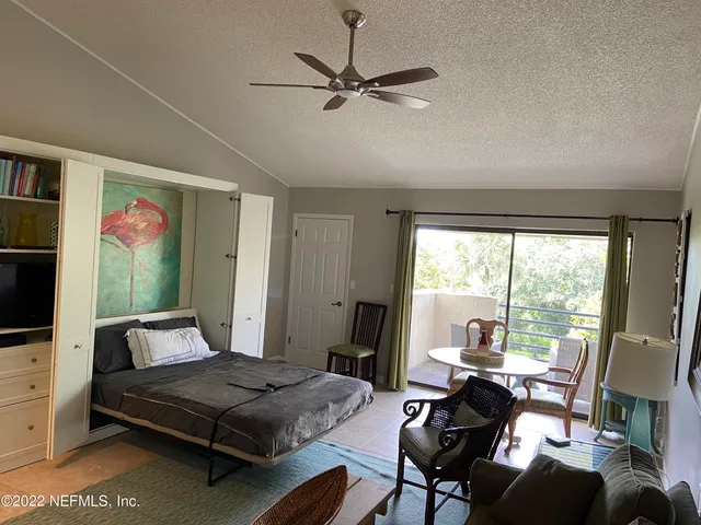 a bedroom with furniture and a window