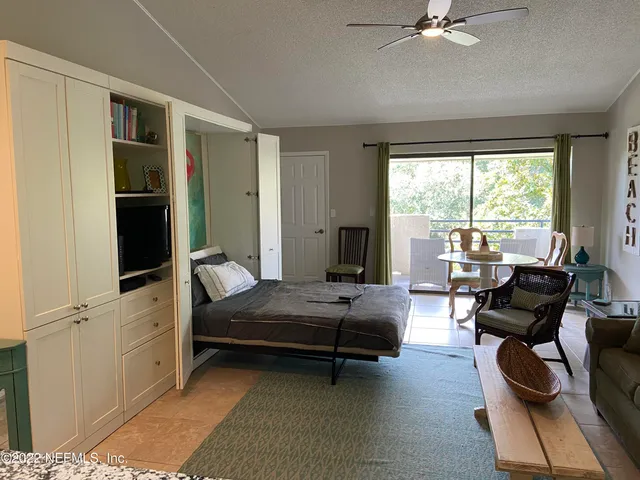 a bedroom with furniture and a window