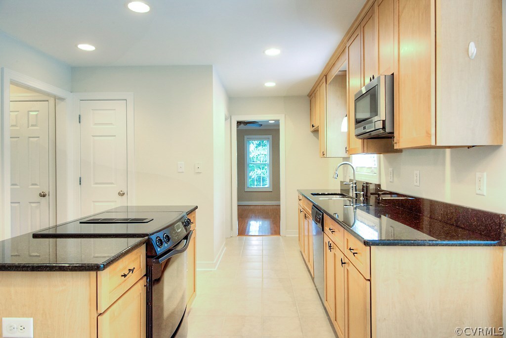 4036 Collingbourne Road Richmond, VA 23235 - Photo 11 of 43 a kitchen with granite countertop a sink and a stove top oven