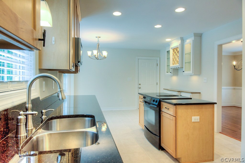 4036 Collingbourne Road Richmond, VA 23235 - Photo 16 of 43 a kitchen with granite countertop a sink a stove and a wooden floor