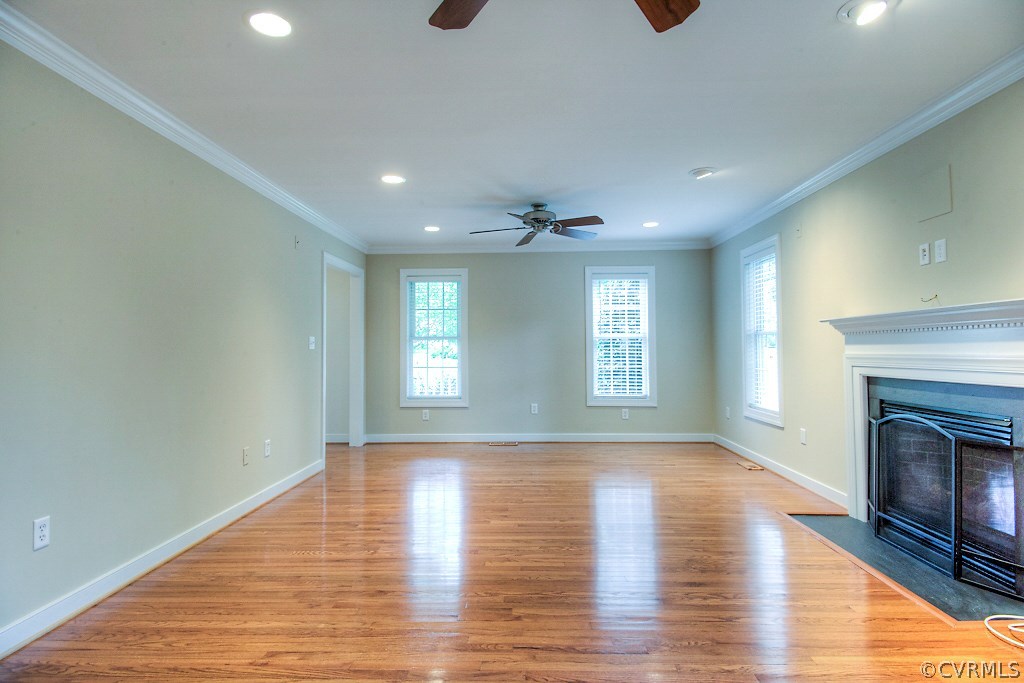 4036 Collingbourne Road Richmond, VA 23235 - Photo 18 of 43 a view of an empty room with wooden floor fireplace and a window