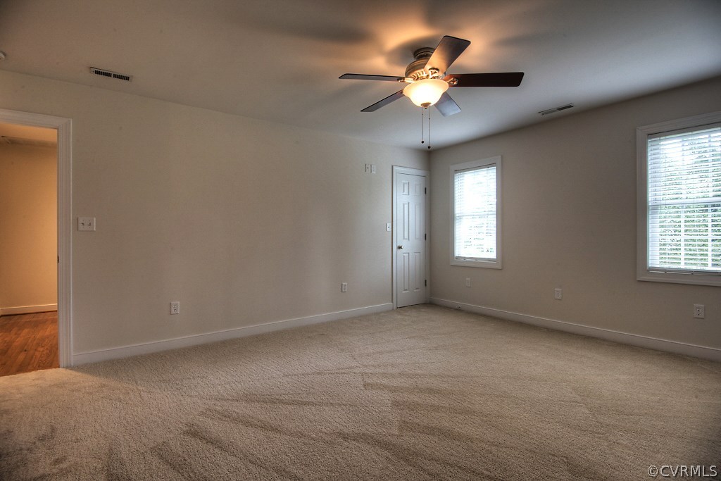 4036 Collingbourne Road Richmond, VA 23235 - Photo 23 of 43 an empty room with windows and chandelier fan