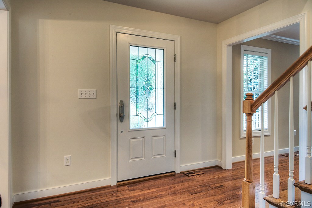 4036 Collingbourne Road Richmond, VA 23235 - Photo 4 of 43 an empty room with wooden floor and windows