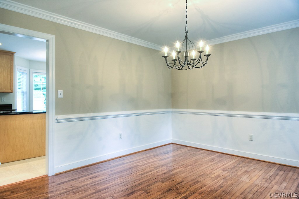 4036 Collingbourne Road Richmond, VA 23235 - Photo 7 of 43 a view of a room with wooden floor and chandelier