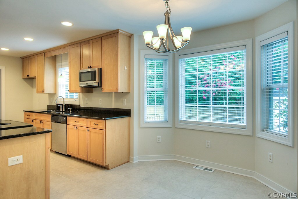 4036 Collingbourne Road Richmond, VA 23235 - Photo 10 of 43 a kitchen with stainless steel appliances granite countertop a stove and a microwave
