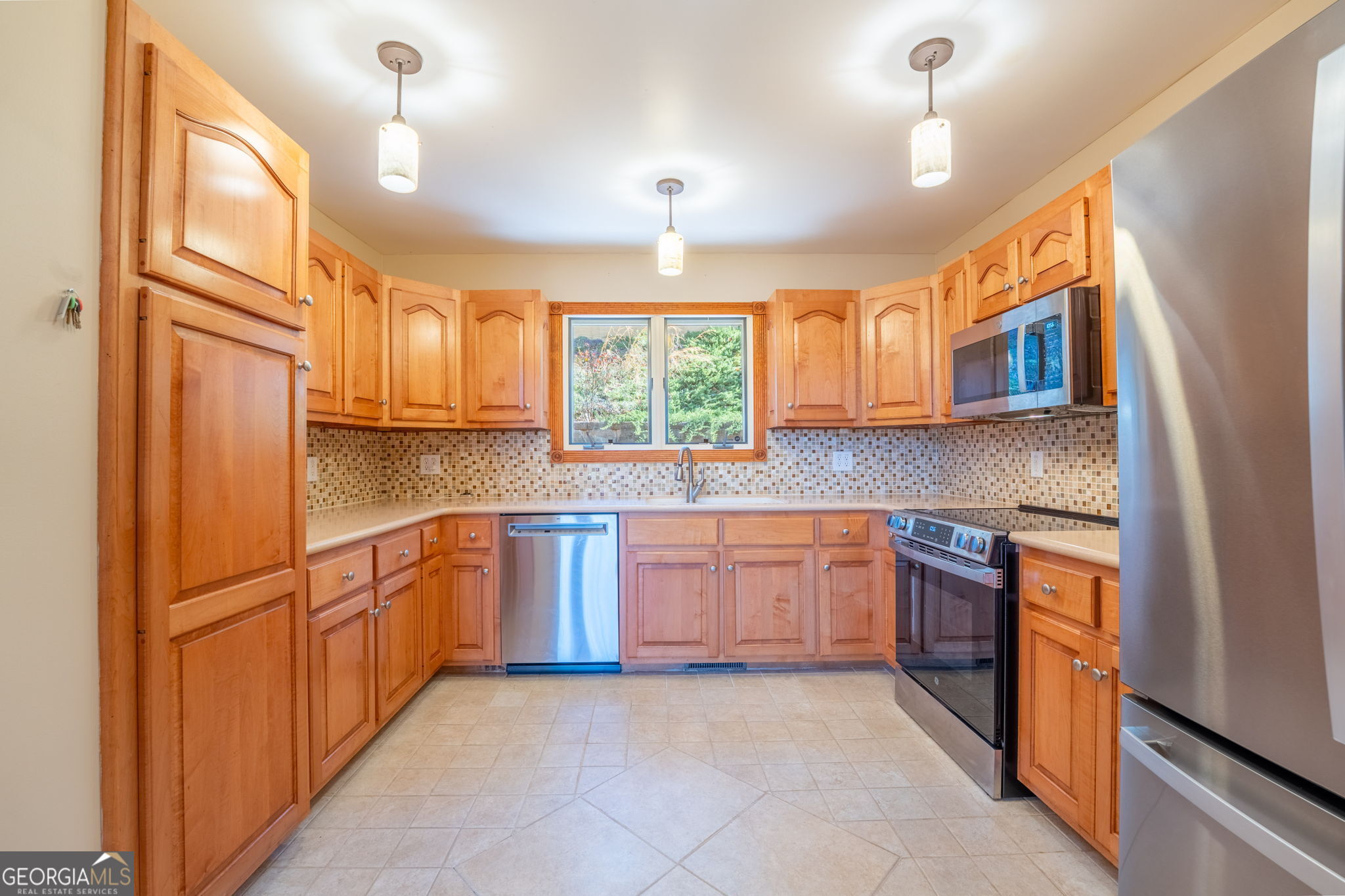 44 Juniper Trail Clayton, GA 30525 - Photo 14 of 87 a kitchen with stainless steel appliances granite countertop a refrigerator a sink dishwasher a stove with wooden cabinets and floor