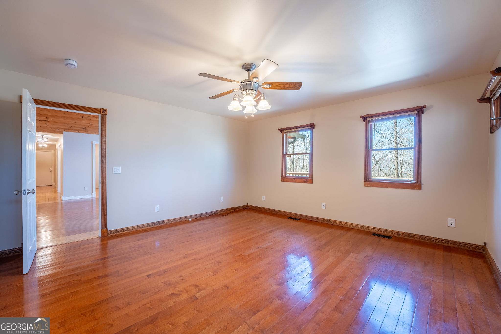44 Juniper Trail Clayton, GA 30525 - Photo 22 of 87 an empty room with wooden floor chandelier fan and windows