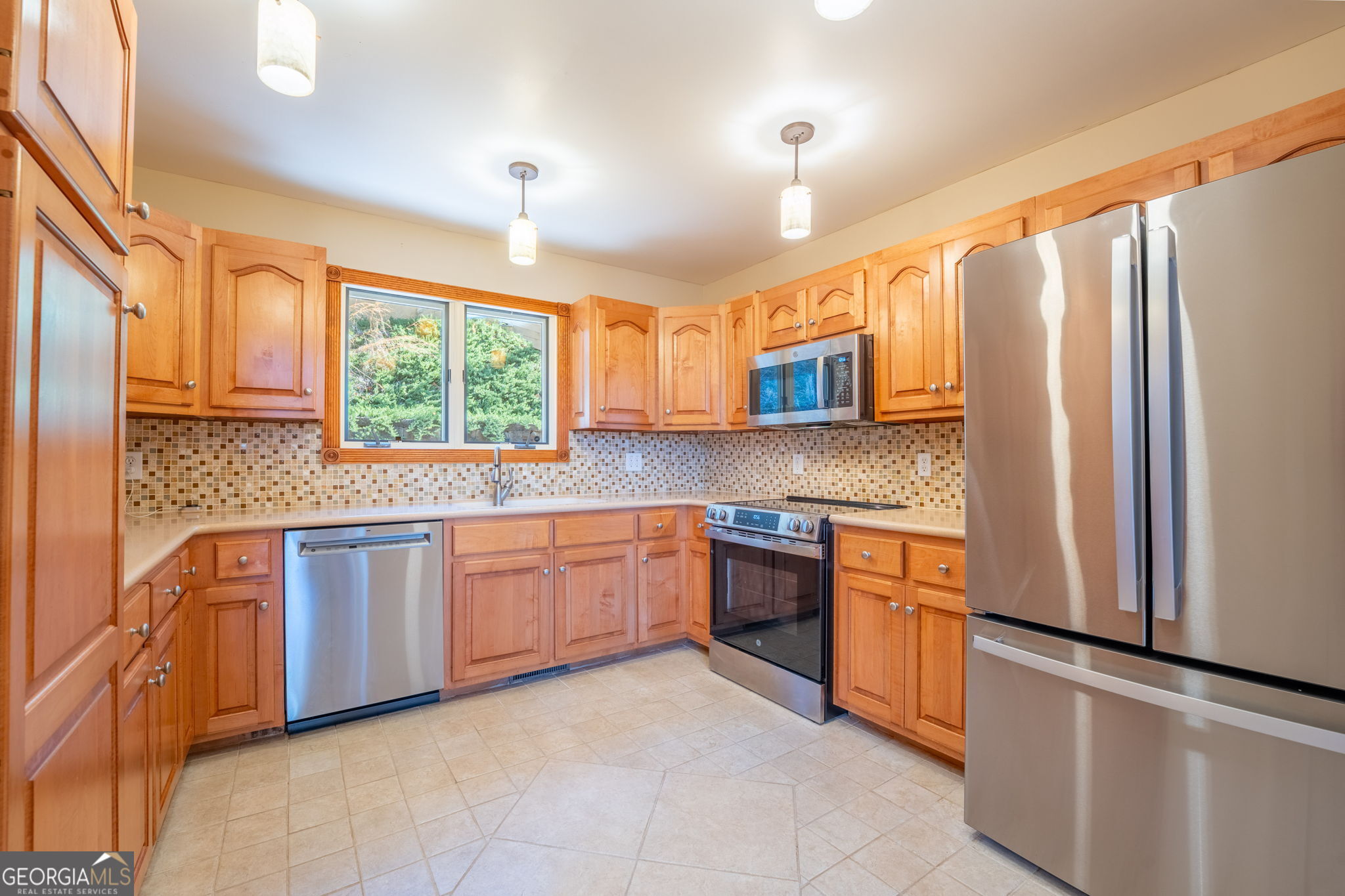 44 Juniper Trail Clayton, GA 30525 - Photo 3 of 87 a kitchen with stainless steel appliances granite countertop a refrigerator a sink dishwasher a stove top oven and a dining table with wooden floor