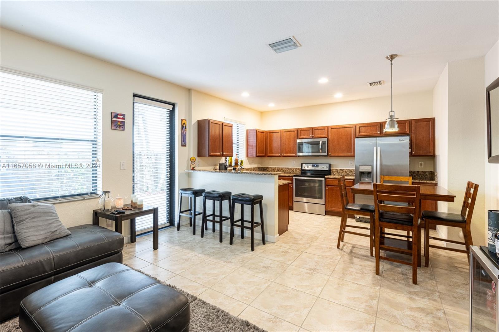 23578 Southwest 113th Path Homestead, FL 33032 - Photo 11 of 59 a living room with stainless steel appliances kitchen island granite countertop furniture and a kitchen view