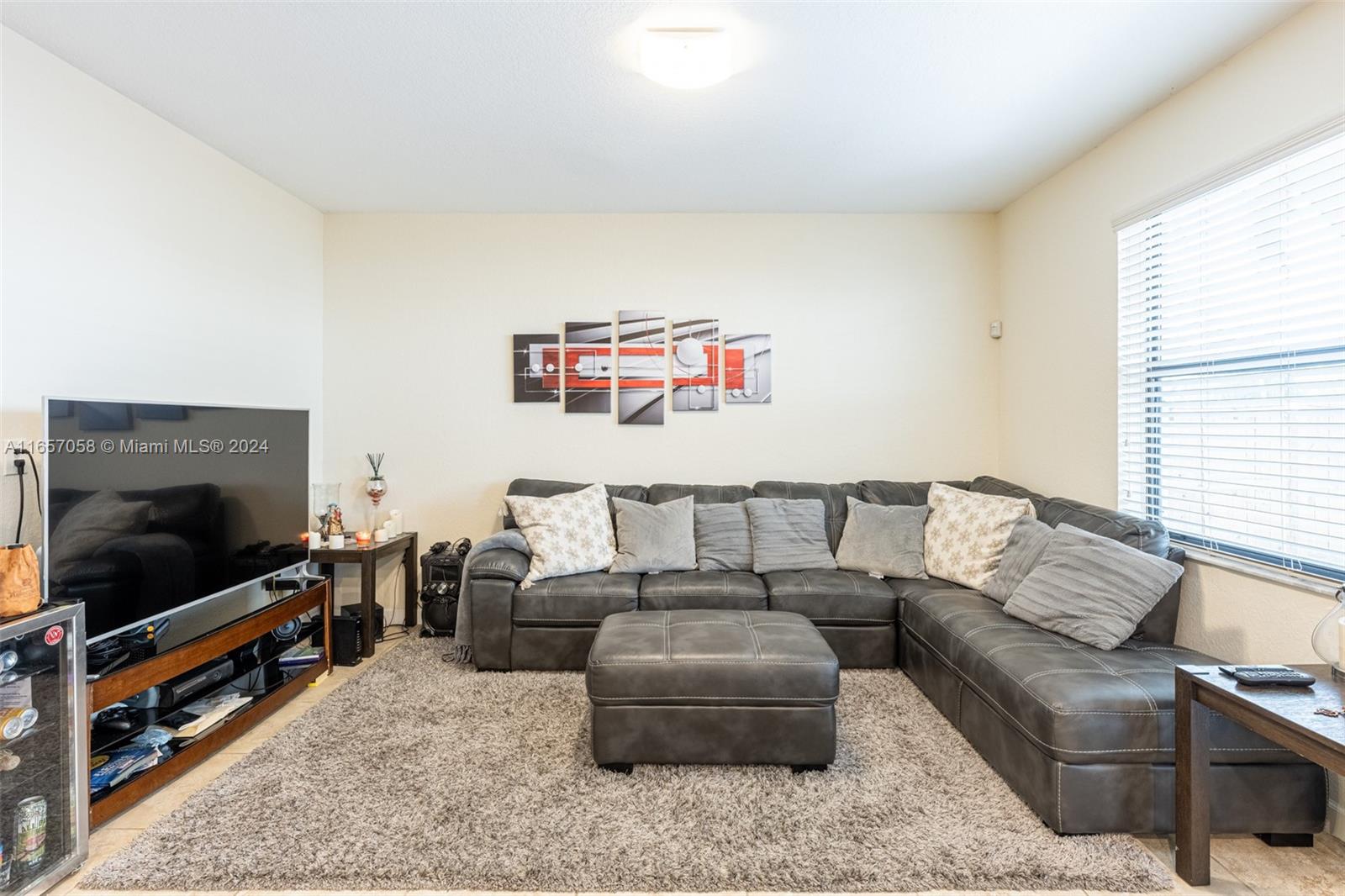 23578 Southwest 113th Path Homestead, FL 33032 - Photo 14 of 59 a living room with furniture and a flat screen tv