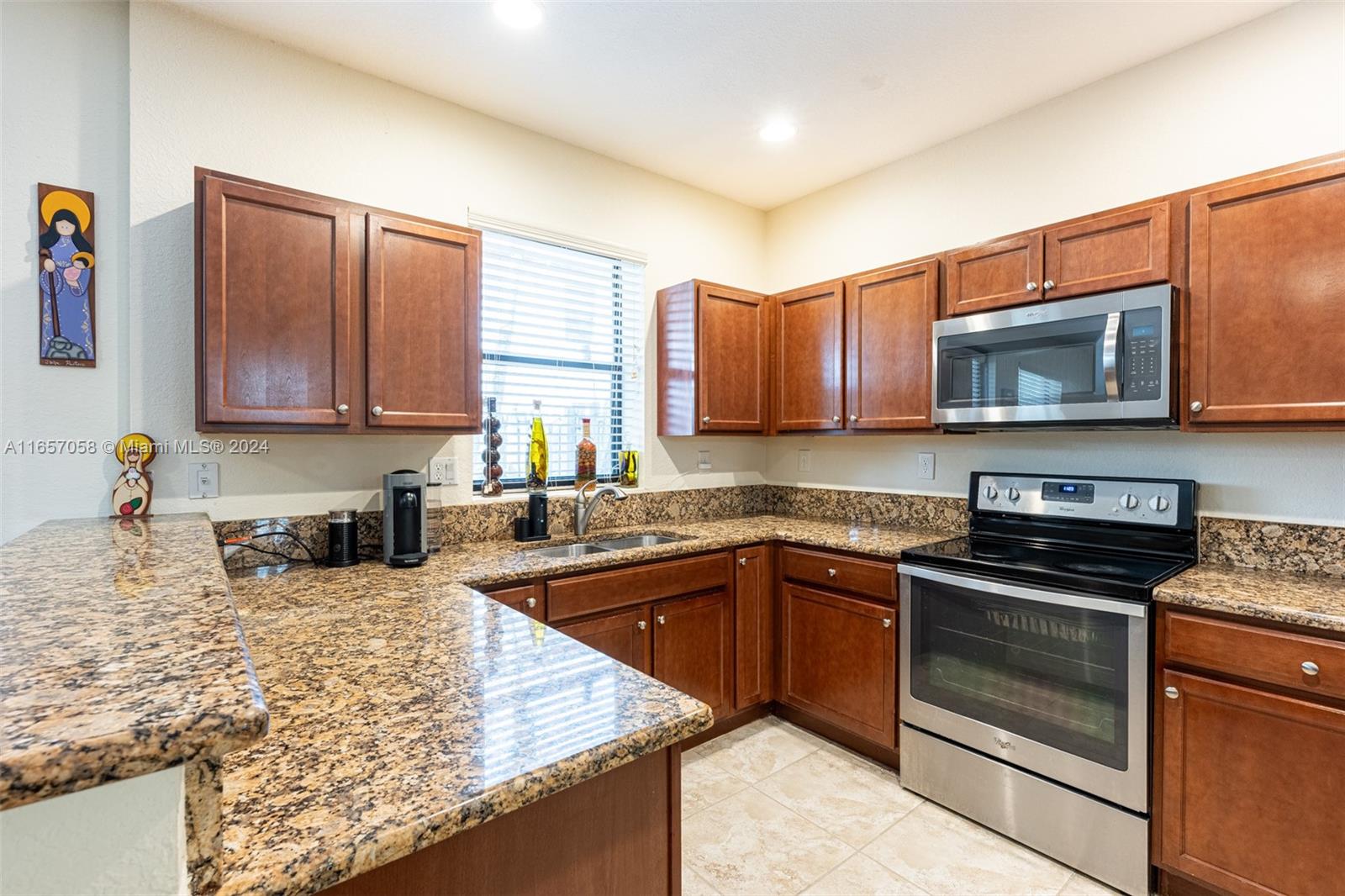 23578 Southwest 113th Path Homestead, FL 33032 - Photo 16 of 59 a kitchen with stainless steel appliances granite countertop a stove microwave and sink
